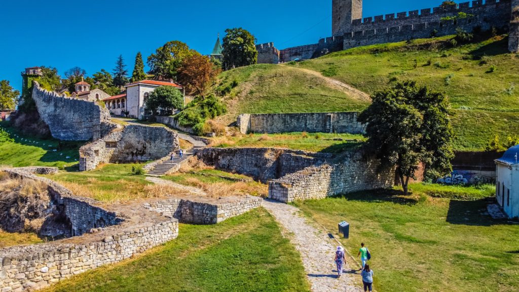 An aerial view of people climbing the Kalemegdan Fortress on a sunny day
