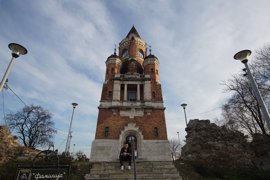 A man sitting on the stairs of the Gardos Tower in Zemun, Serbia