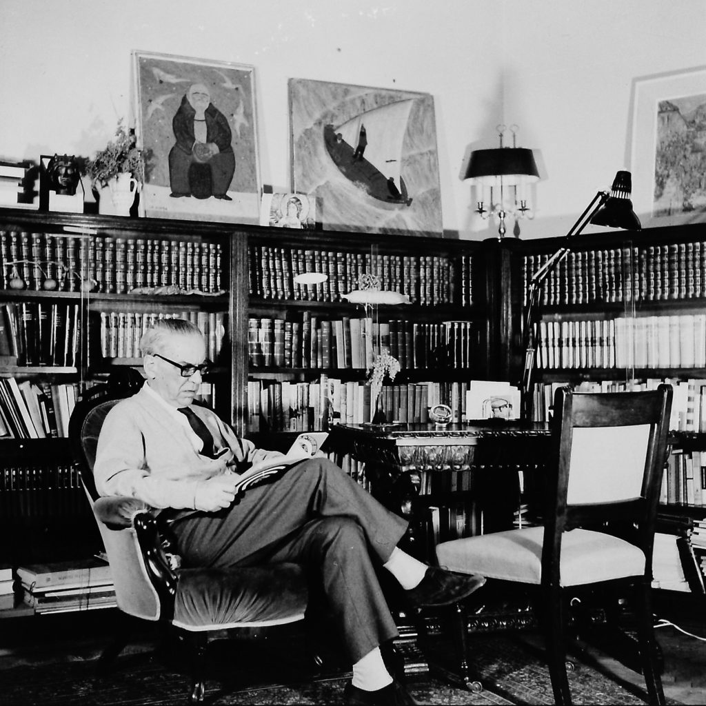 Ivo Andric sitting and reading in his library